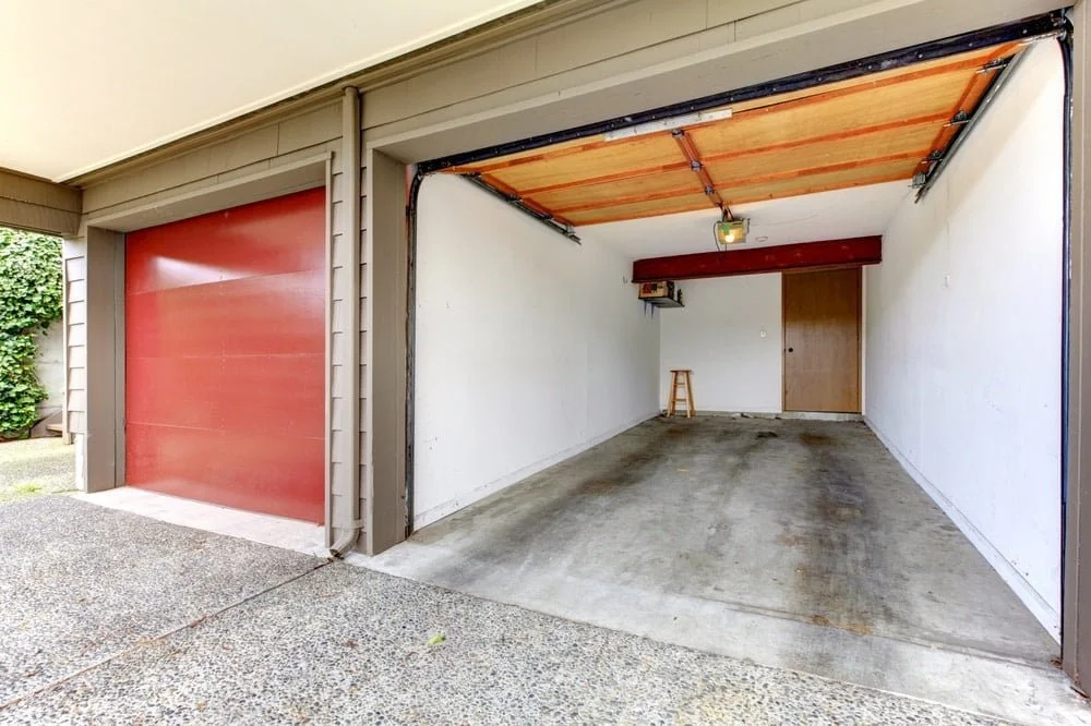 Double garage with red doors one of them is opened