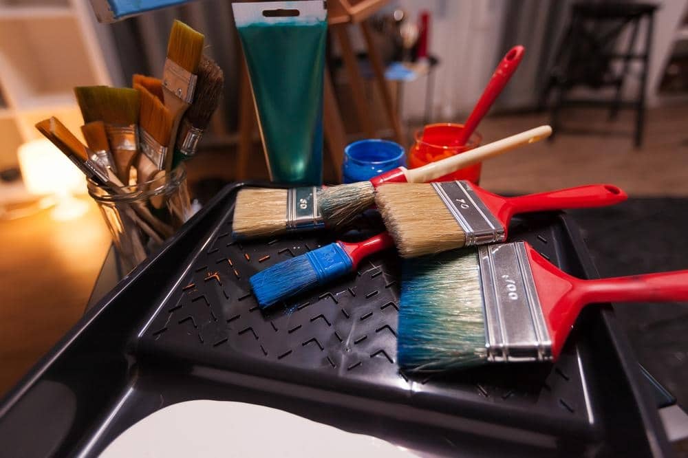 Paint brushes on a black plastic paint holder