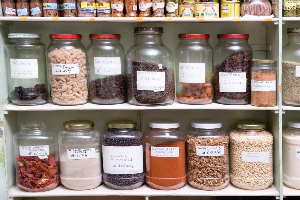 Labeled food jars on pantry shelves