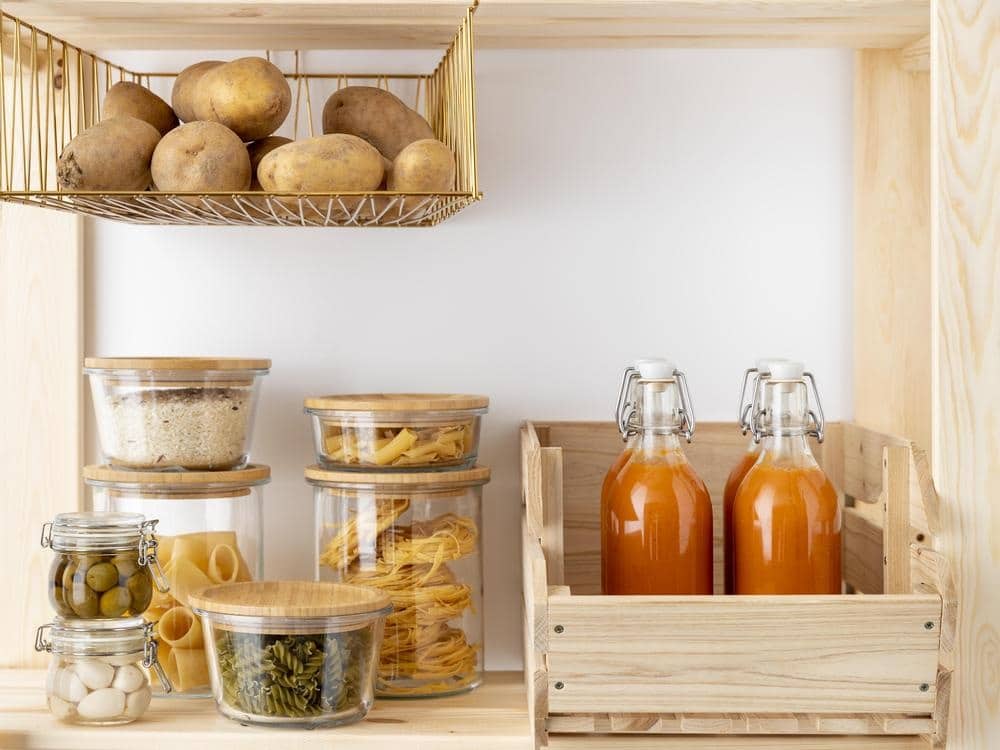 Food containers and jars on a wooden shelf