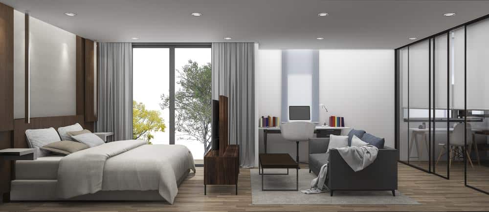 Modern bedroom design that has dark colored furniture