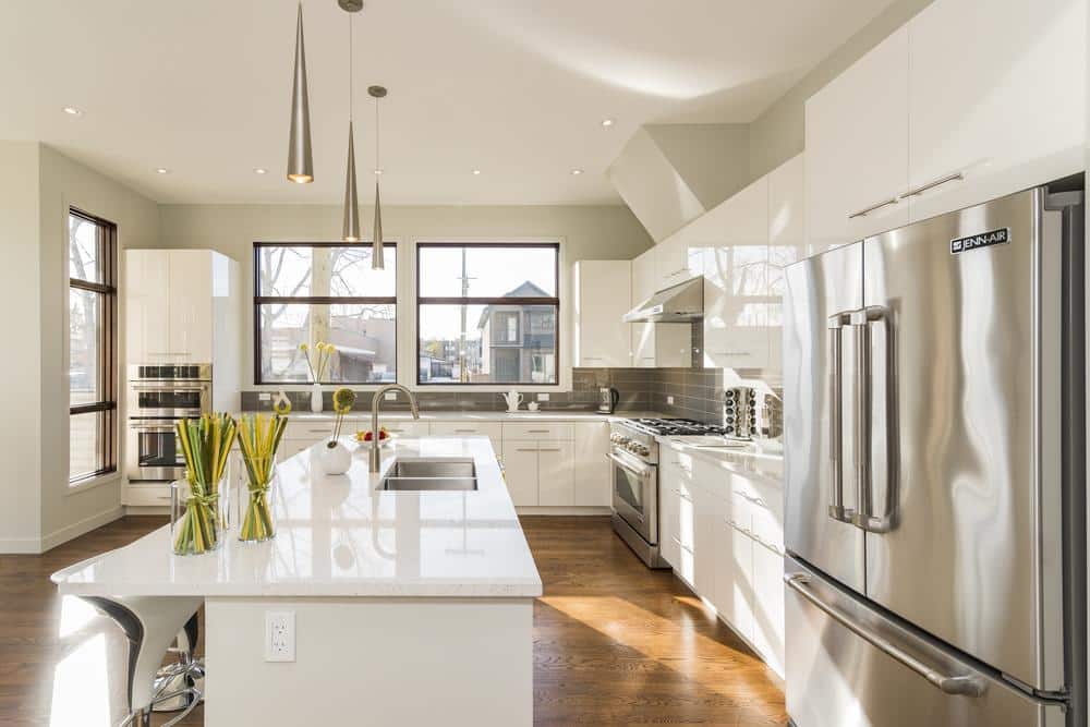 Natural lighted large kitchen with white island and cabinets