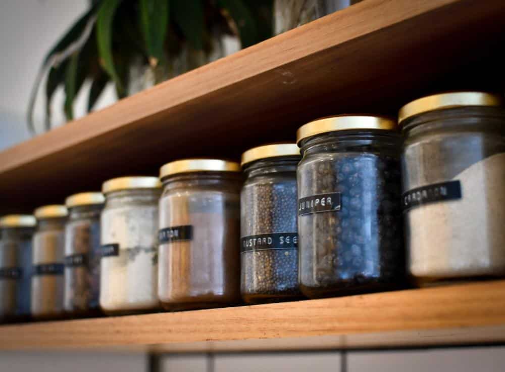 Wooden shelves with labeled food jars