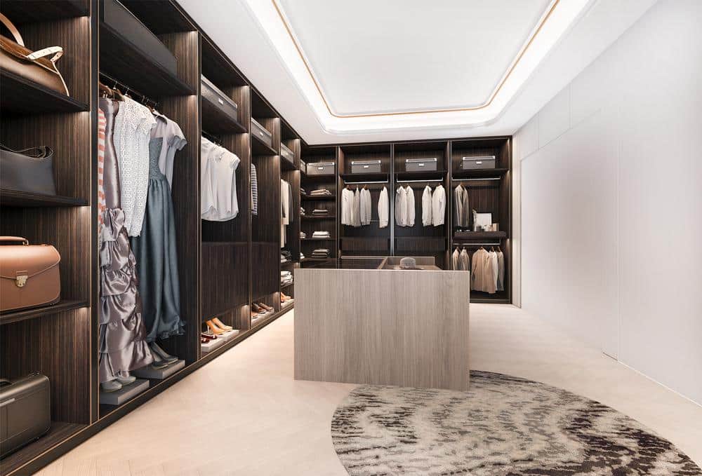 Walk in closet that has island on the middle