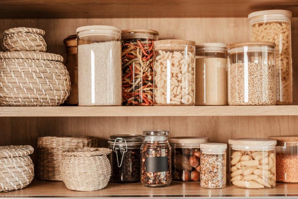 Two wooden pantry shelf with jars