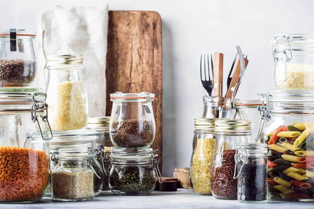 Kitchen utensils and food jars on a surface