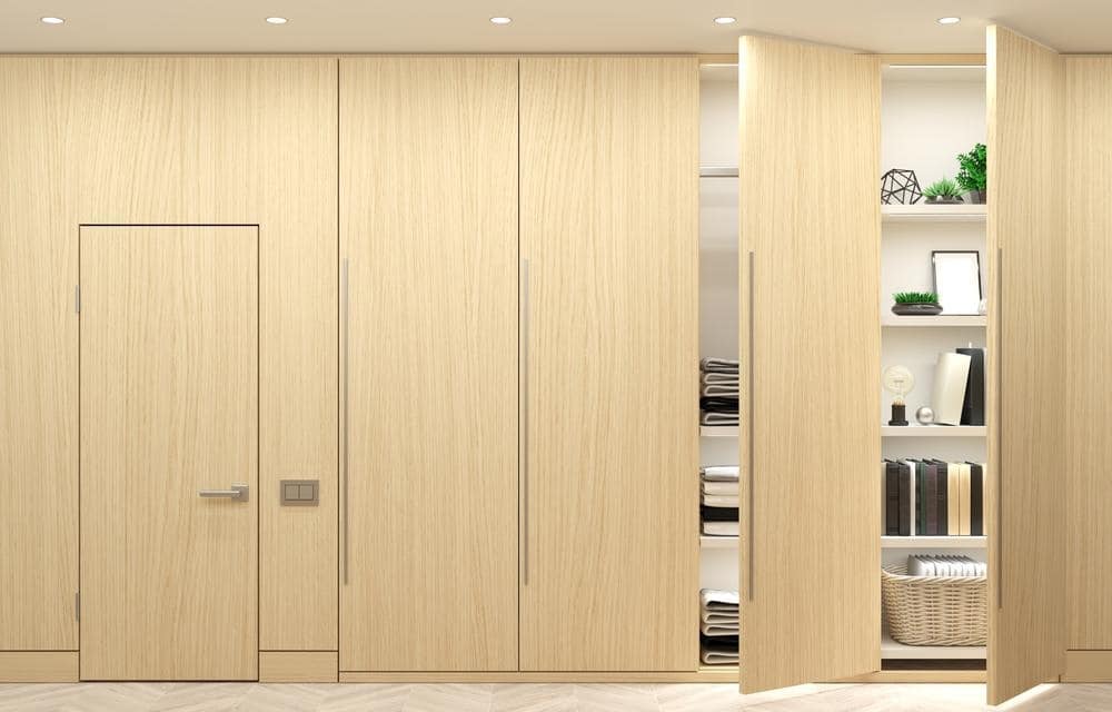 Wardrobe closet design that has tall wooden doors