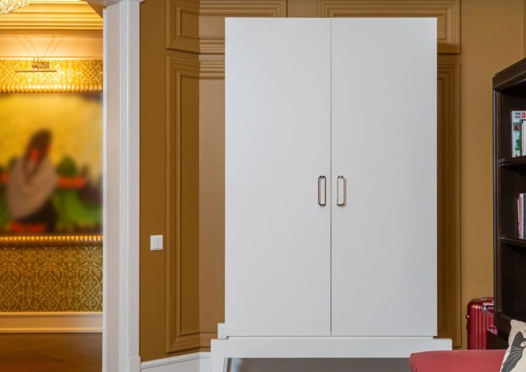 White wardrobe closet standing in a room