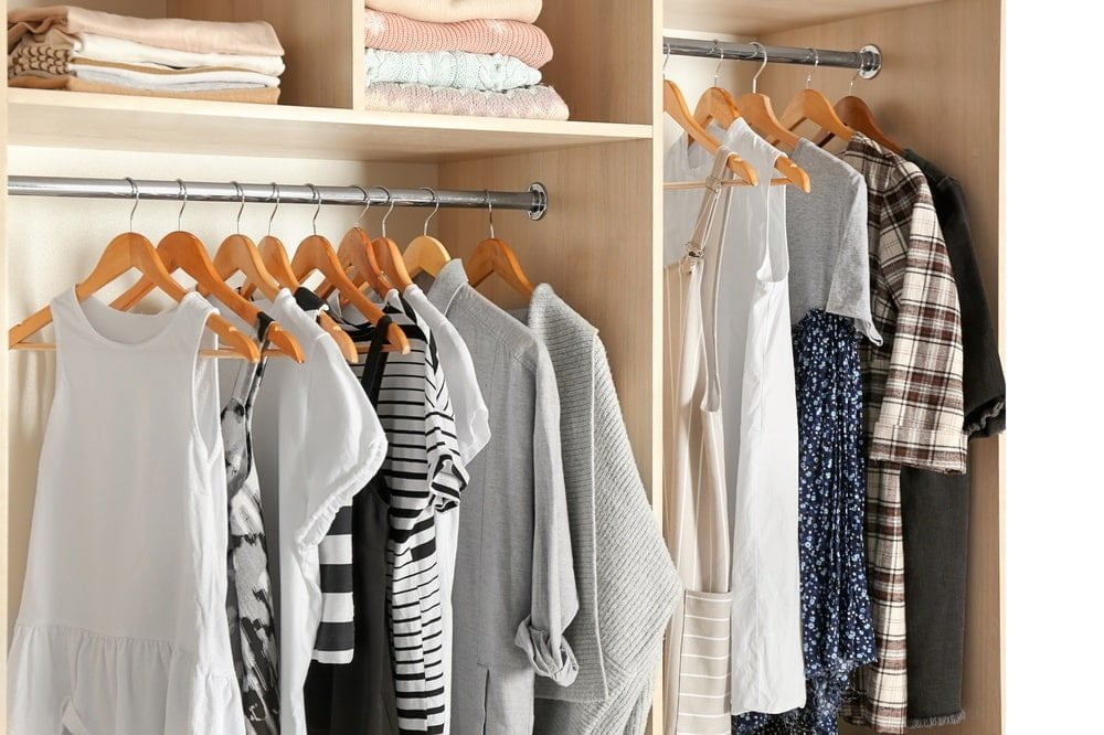 Clothing racks in a wooden wardrobe