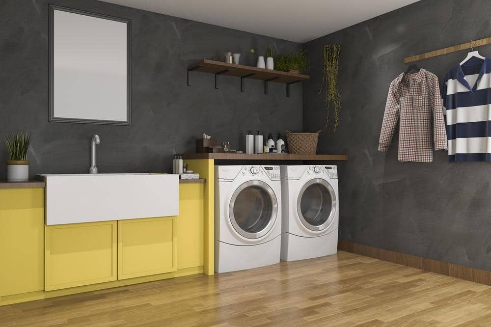 Laundry room with wooden flooring and washer set