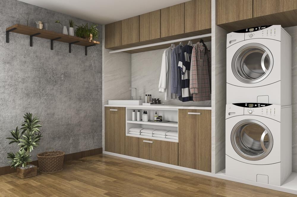 Modern laundry room with cabinets shelves and hangers