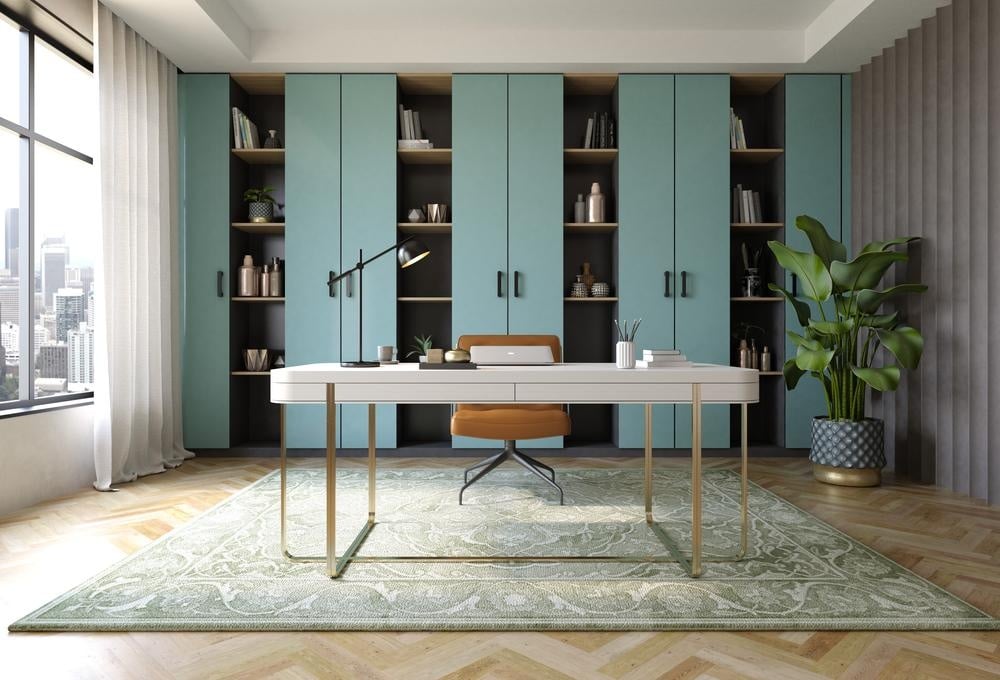 Light blue wall cabinets in a home office with white desk and a chair