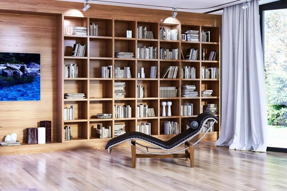 A room with built in bookcase covering the wall and filled with books