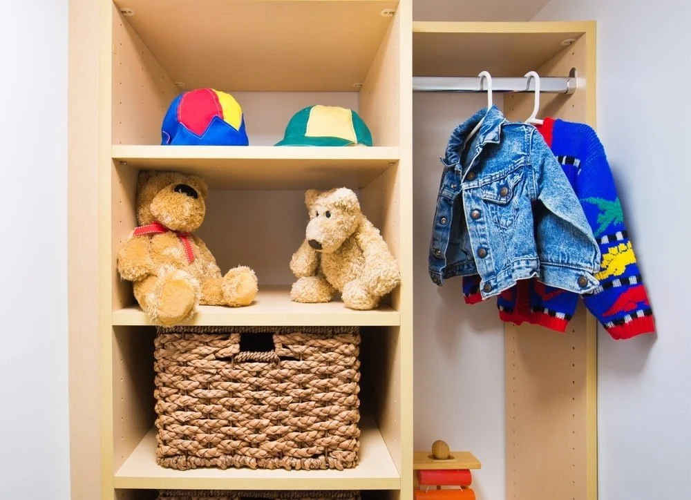 small kids closet with hangers and shelves