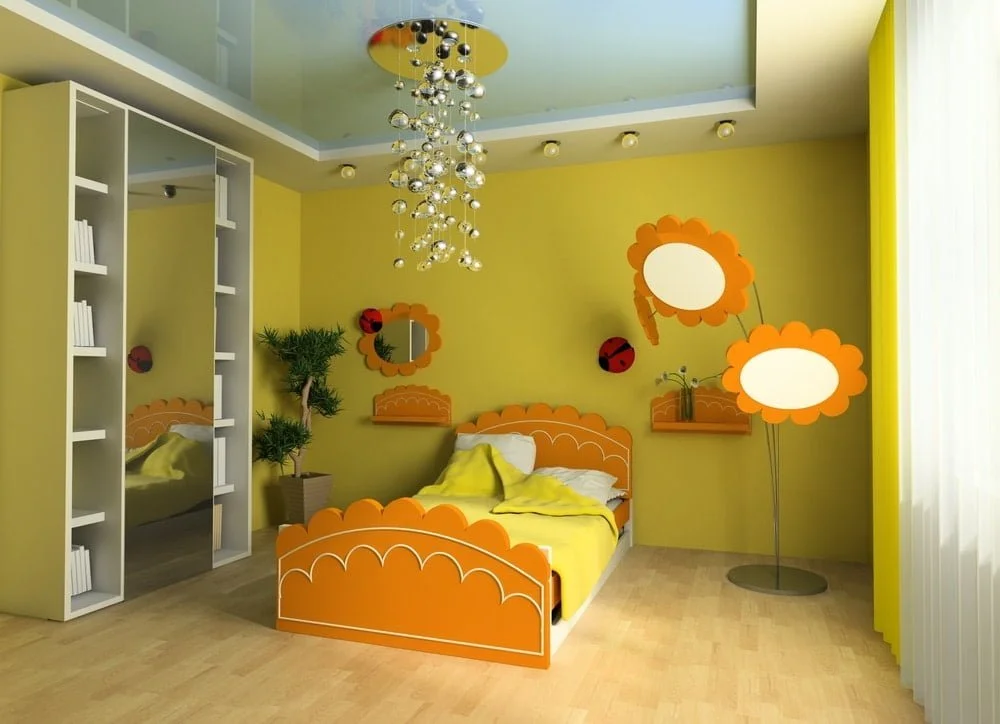 Yellow wall kids room with open children's closet and a bed next to the lights