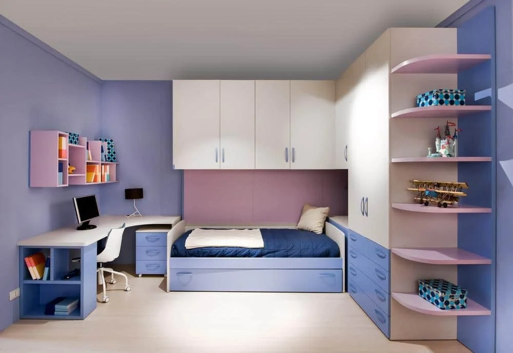 Teenage room with blue pink and white furniture like drawers shelves and closets