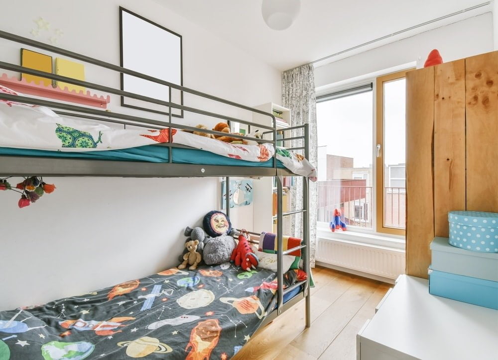 Kids room with bunk bed and wall window