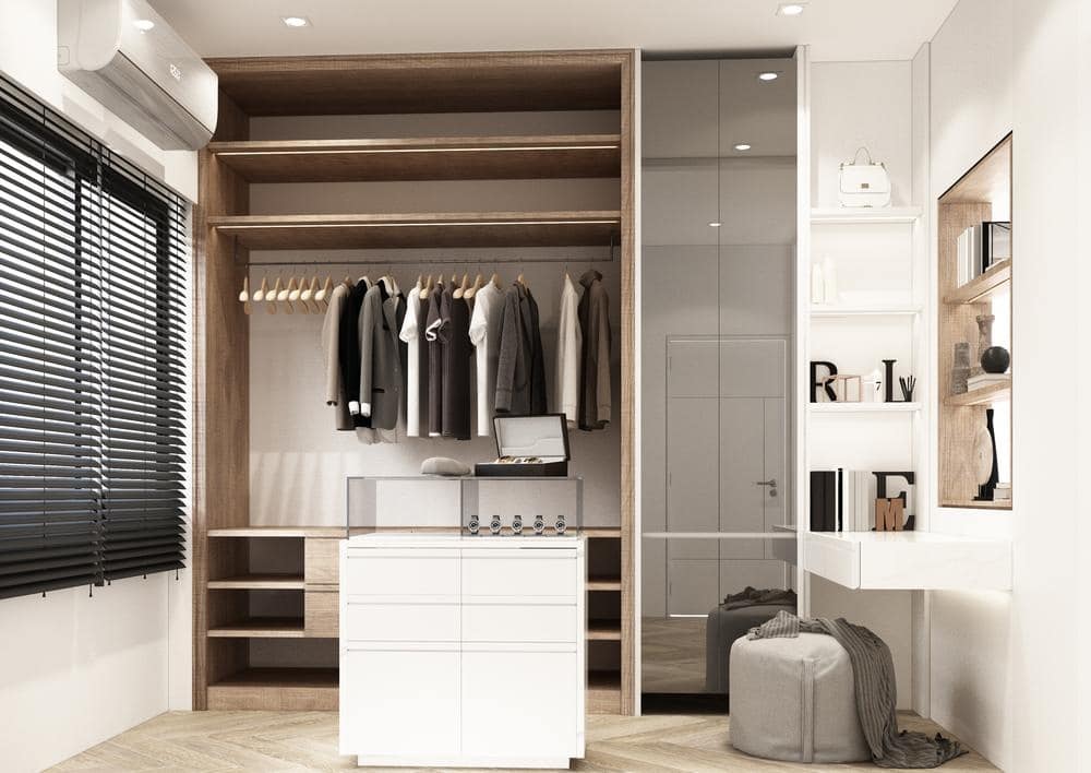 small reach in closet in a bedroom with small white island