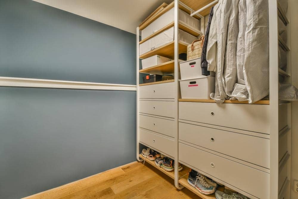Modern white standing closet with drawers and hangers