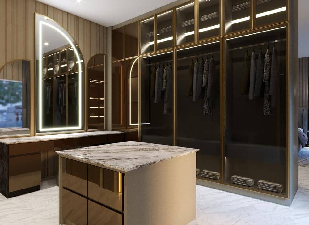 Modern walk in closet with dark glass closet doors and a small island in the middle