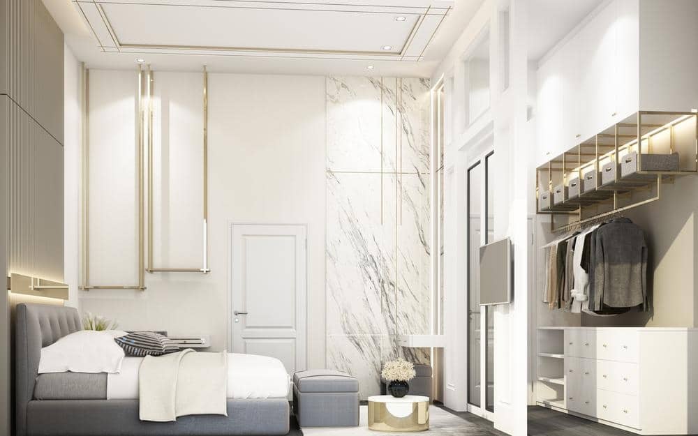 white modern bedroom with reach in closet with open clothing hangers