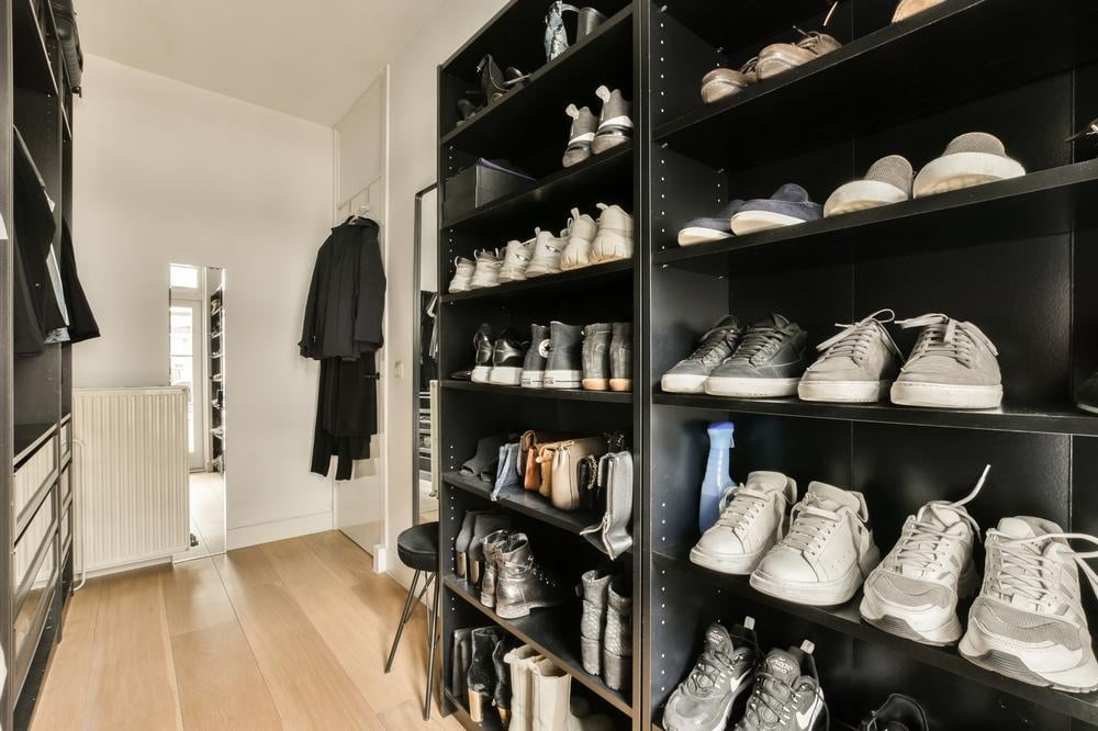 Room with shoe rack filled with shoes