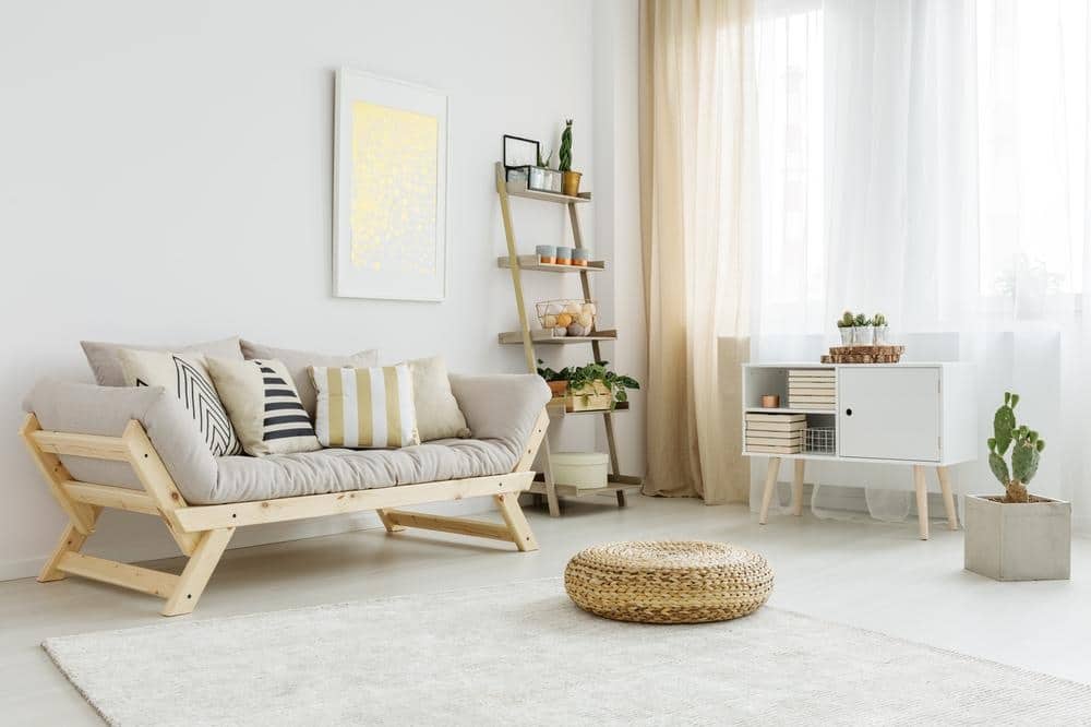 Beige and white living room with cozy furniture like couch and ottoman and rug