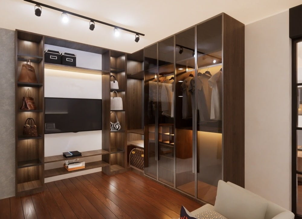 Luxury brown walk in closet with glass doors