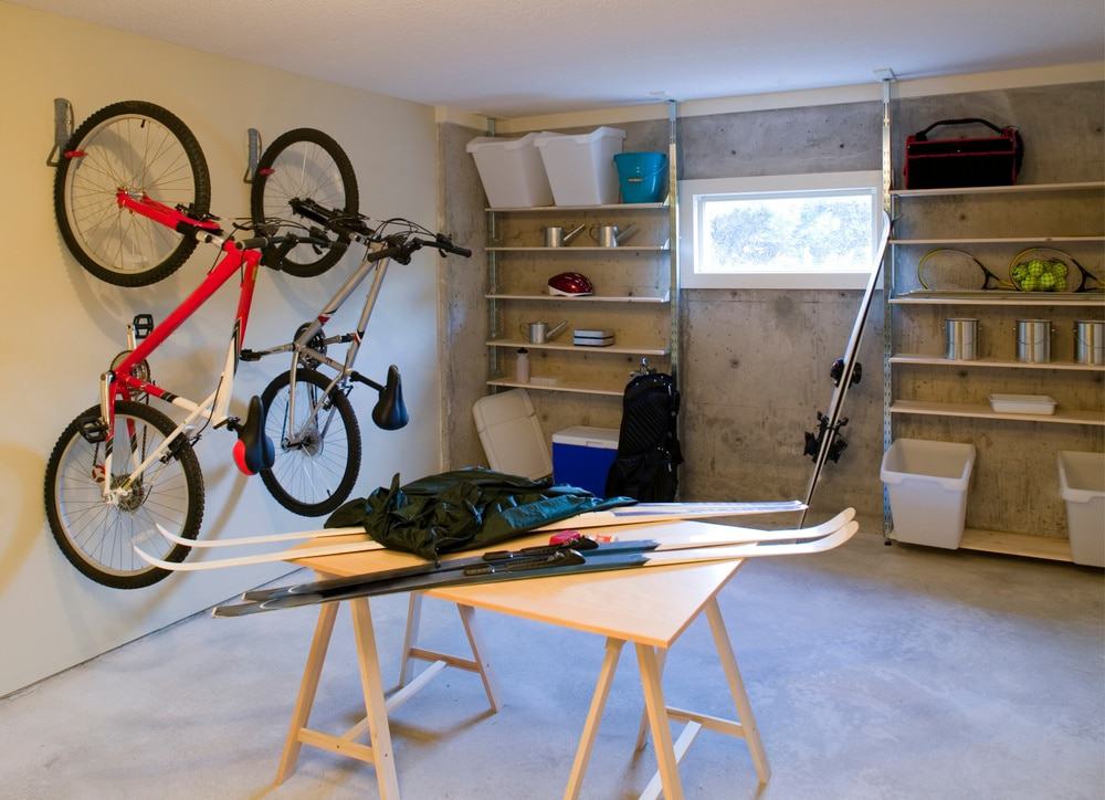 Small garage with wooden workstation and wall shelves