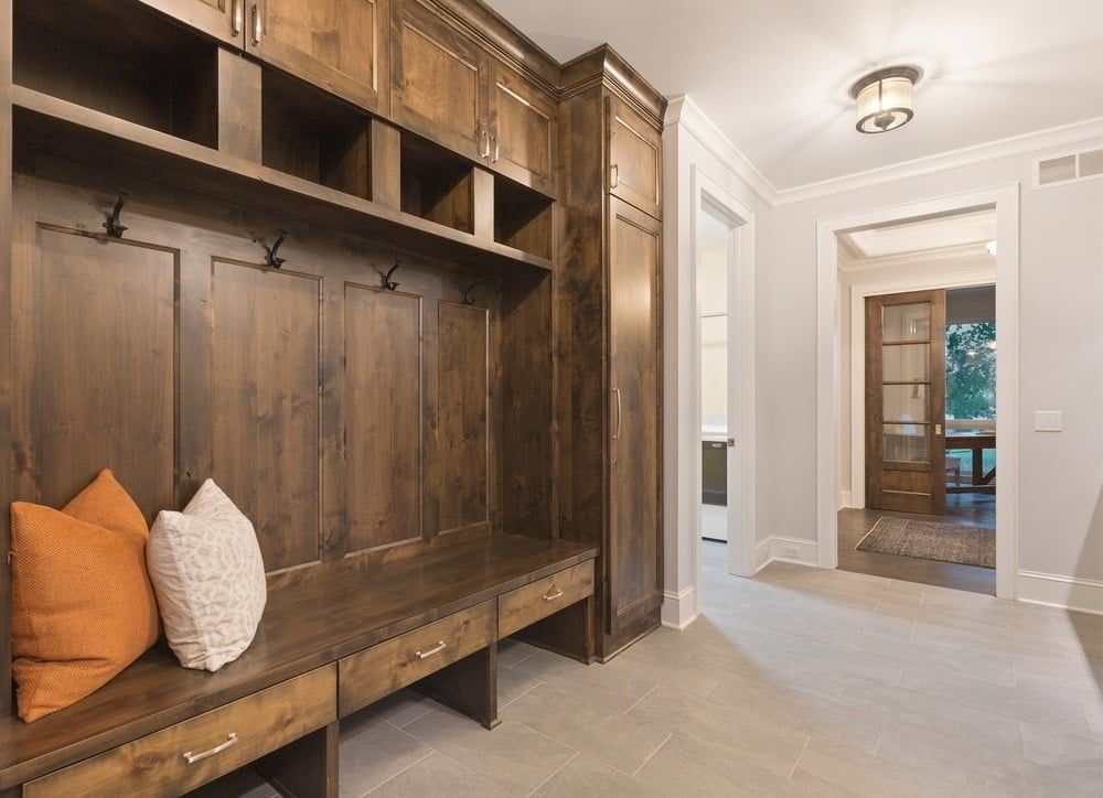 Dark mudroom with cabinets and open shelves in the entryway