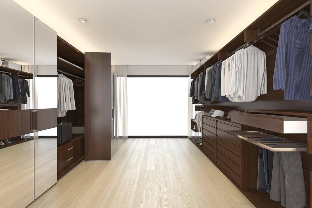 Wooden floor walk in closet with closet with mirror doors