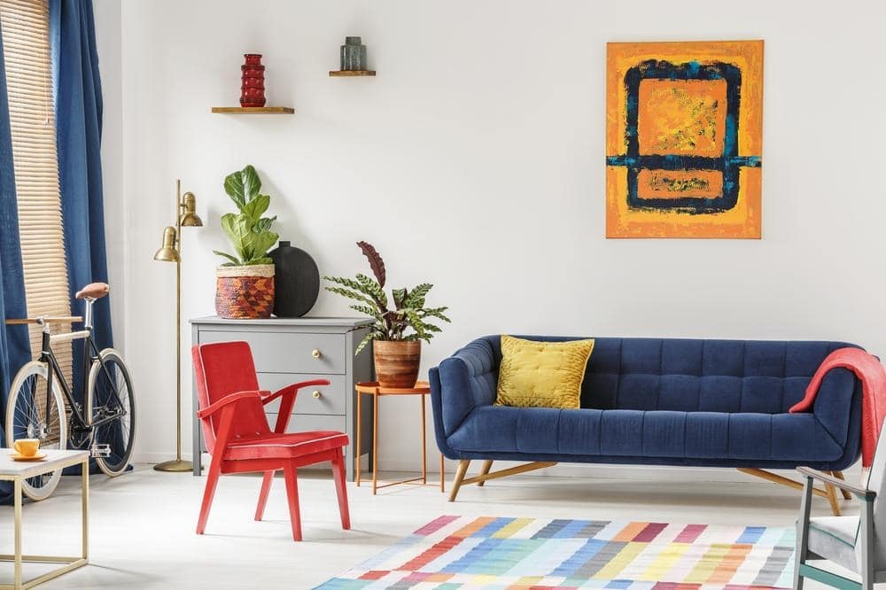 Living room with blue couch and red chair