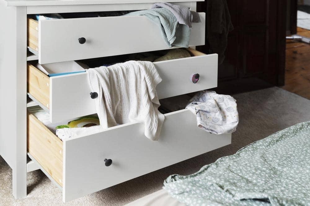 Drawers opened halfway and has clothes inside free-standing closet systems