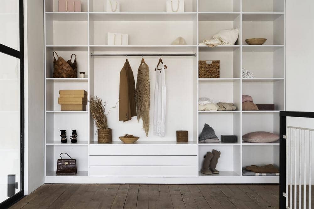 White standing closet with open shelves and sections