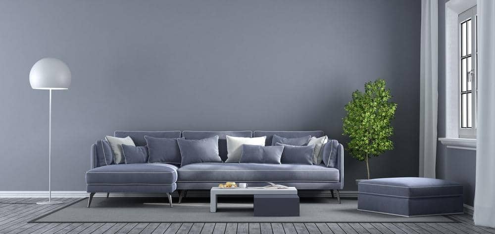 Grey living room with grey furniture like a couch and an ottoman