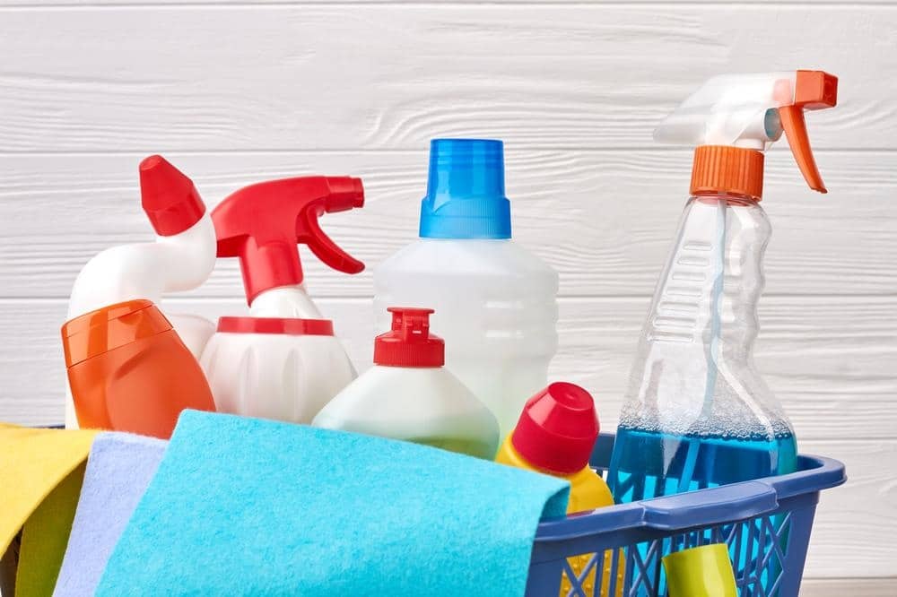 Cleaning supplies in a blue basket