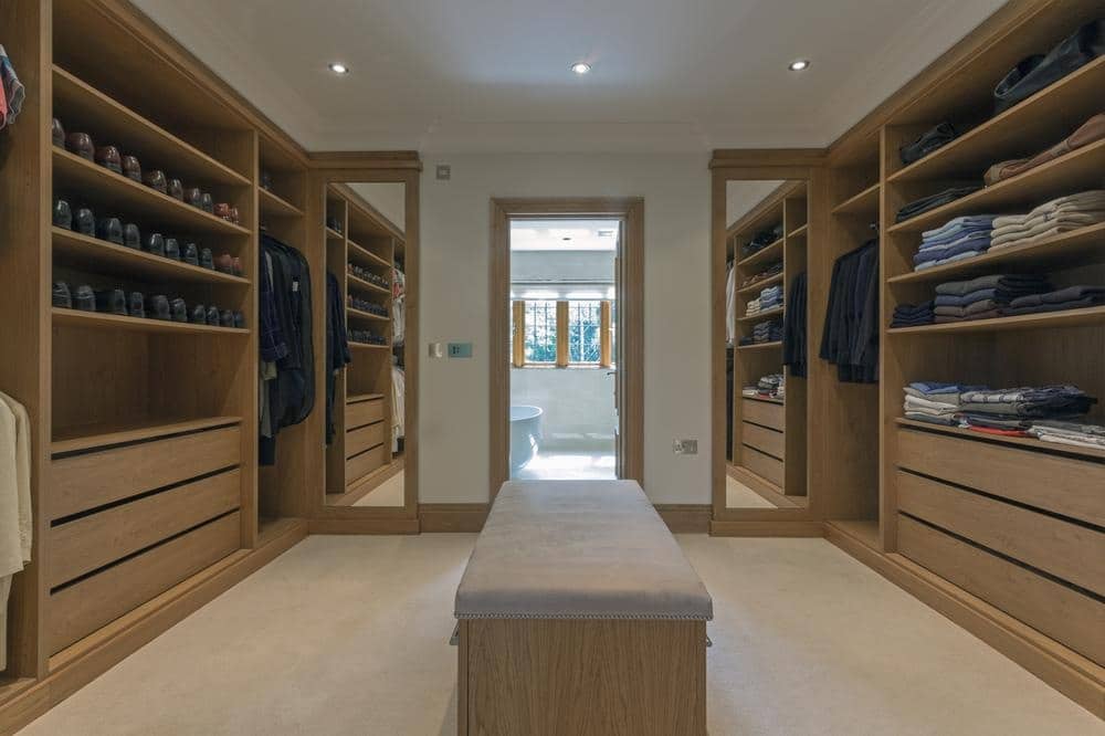 Large walk in closet with wooden shelves and closets