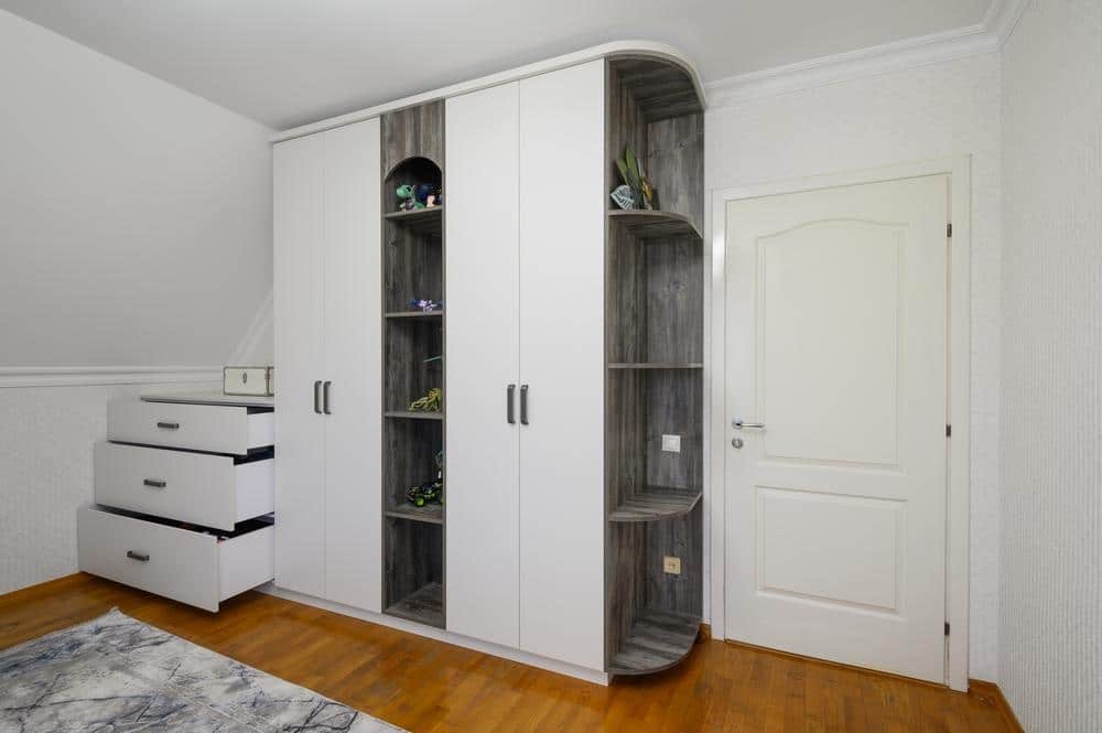 White closet with dark open shelves between its doors