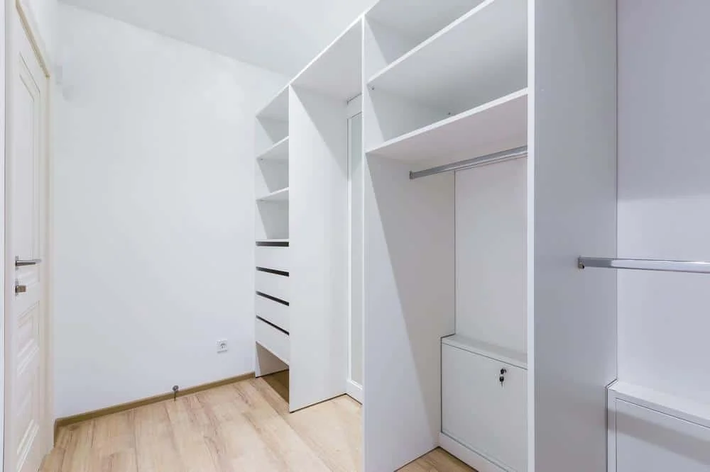 The Power of Simplicity: Embrace Elegance with These 14 White Wardrobe Closet Ideas 12 White empty wardrobe closet with shelves and hangers