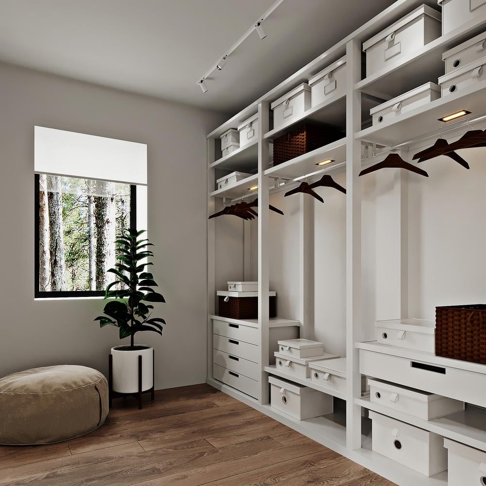 White built in closet with empty hangers and storage boxes on its shelves