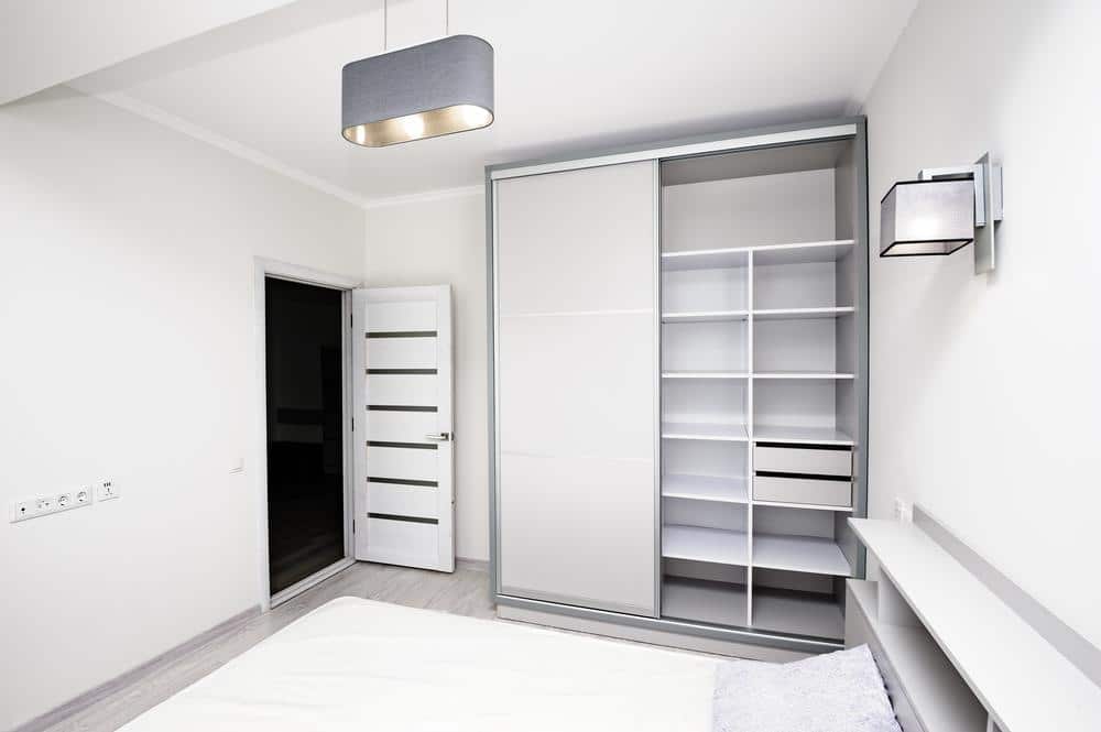 White custom closet with white shelves and doors
