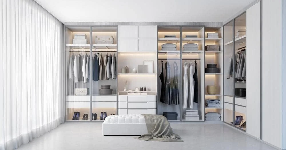 The Power of Simplicity: Embrace Elegance with These 14 White Wardrobe Closet Ideas 14 Modern closet with glass doors and ottoman in front of it