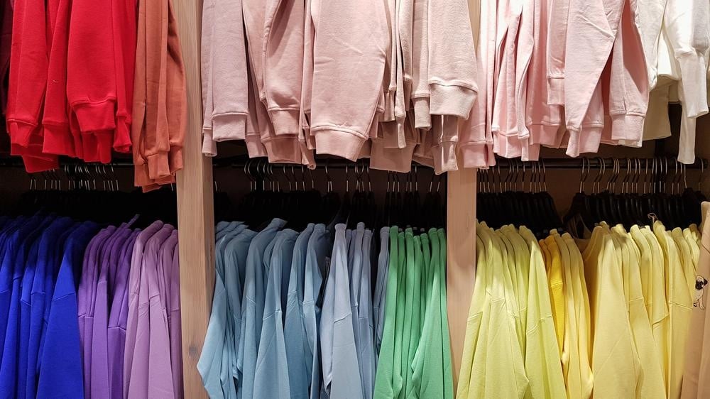 colorful clothes hanging on hangers close to each other