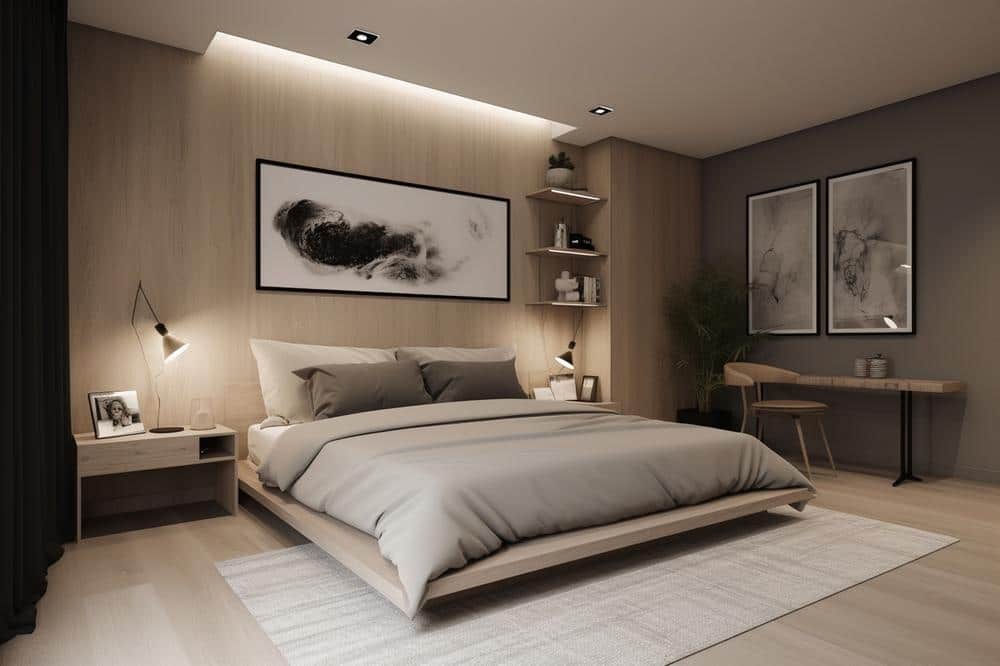 Modern bedroom with artwork hung above the bed and workstation