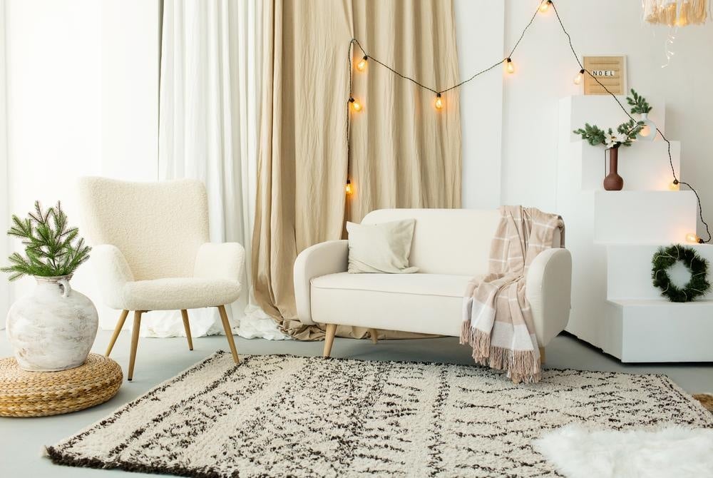 White cozy living room corner with two white armchairs and a patterned rug