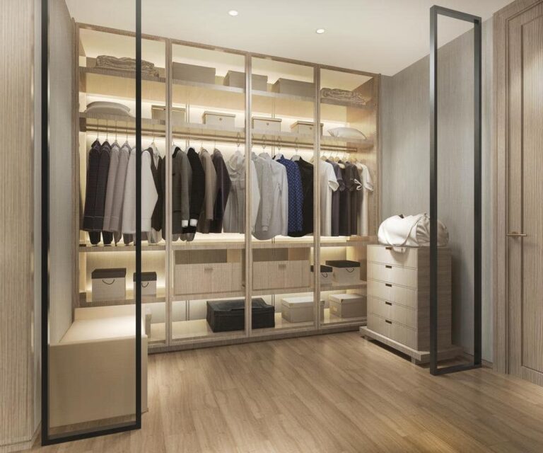 Glass door walk in closet with lighted shelves