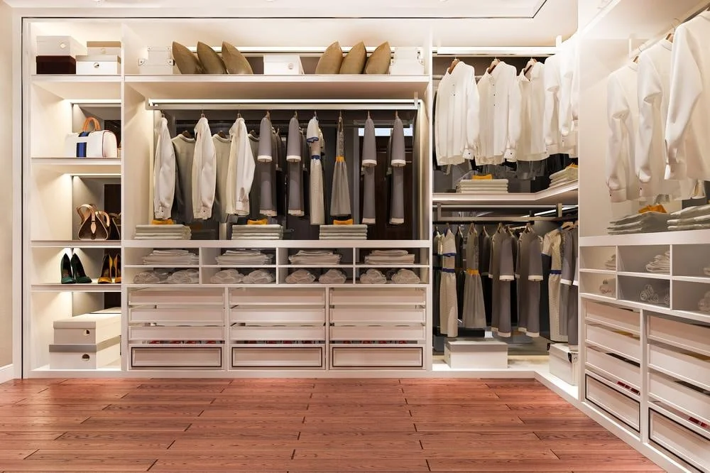 White walk in closet with clothes inside