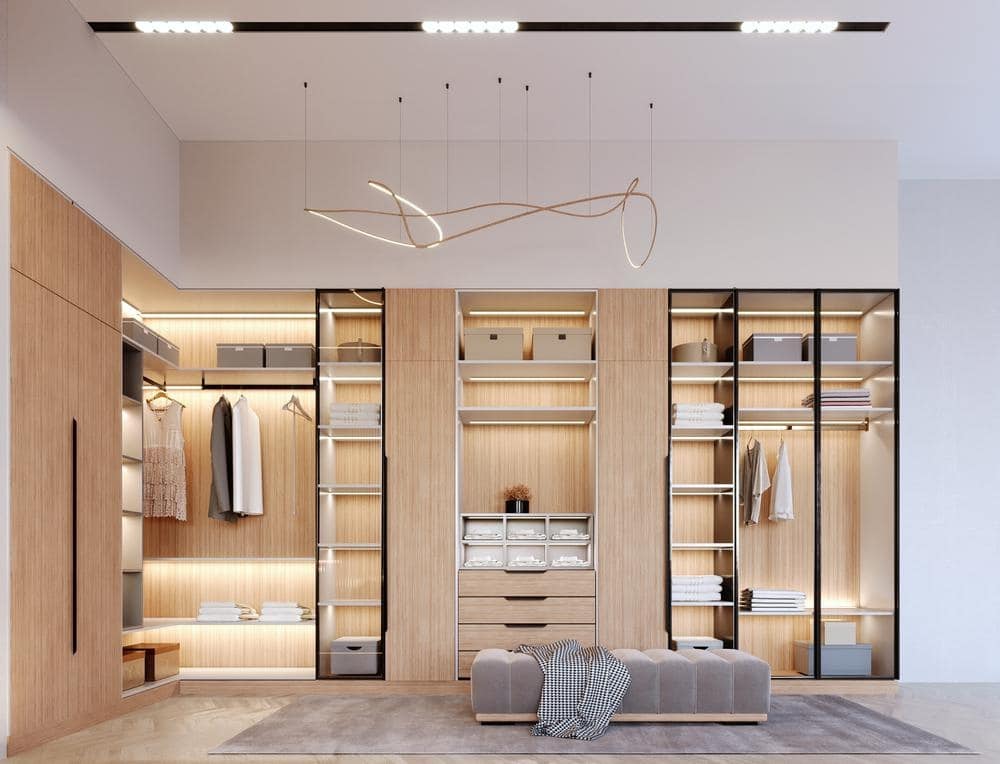 Light wooden built in closet with glass inserted doors
