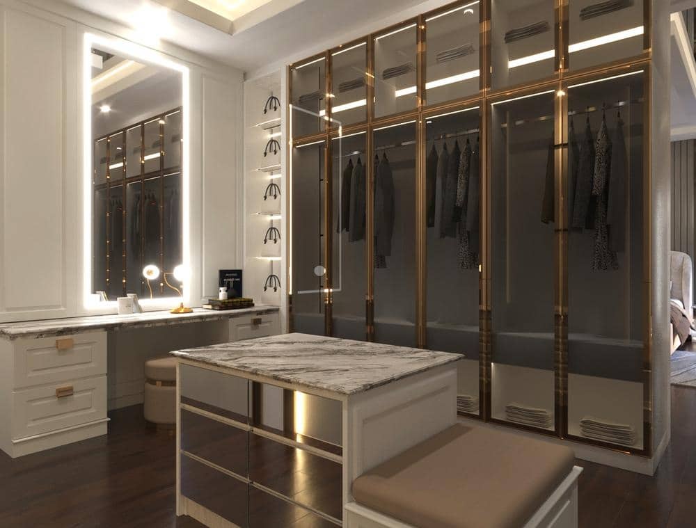 Custom walk in closet with darkened glass doors and led lighted mirror in the room