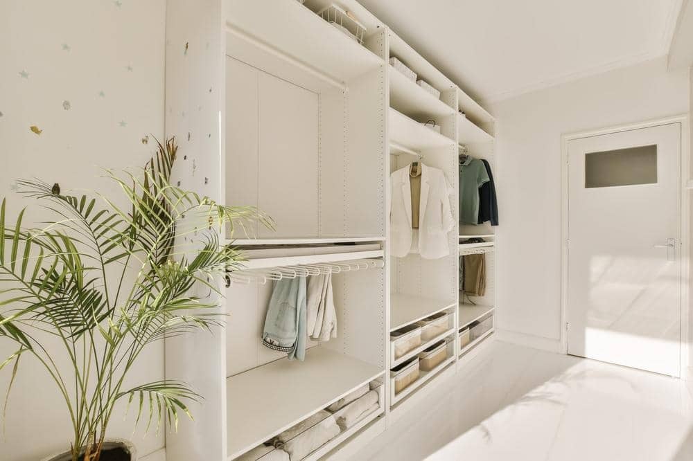 modern white simple closet with no doors and there are hanging rods